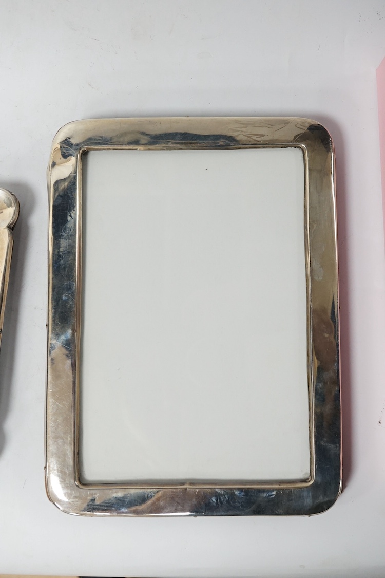 An Edwardian silver mounted photograph frame, King & Sons, Birmingham, 1907, 23.7cm, together with two later George V silver mounted photograph frames, Birmingham, 1917 and Birmingham, 1925. Condition - fair